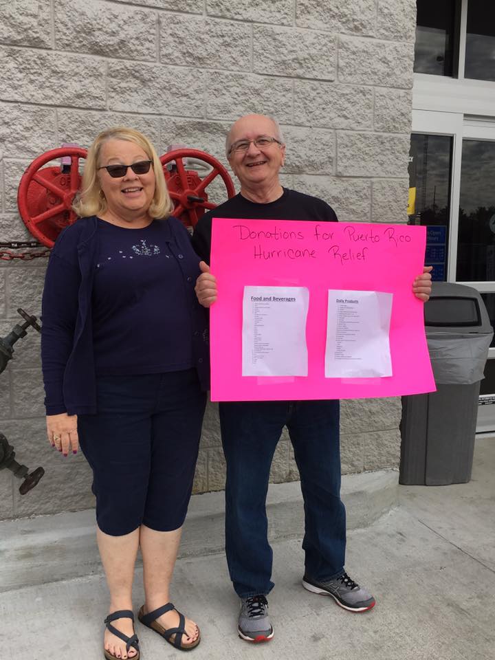 Employees with sign for hurricane relief