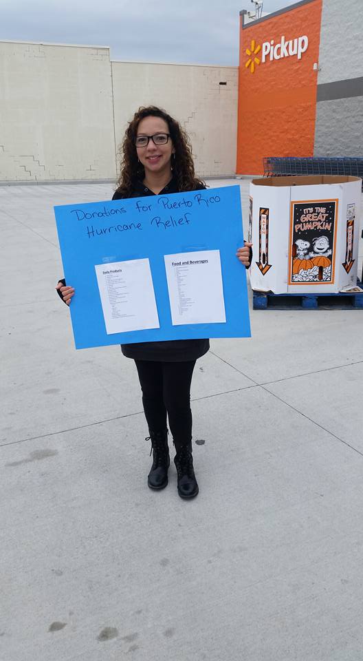 Employee with sign for hurricane relief